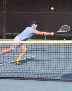 guy hitting ball during tennis