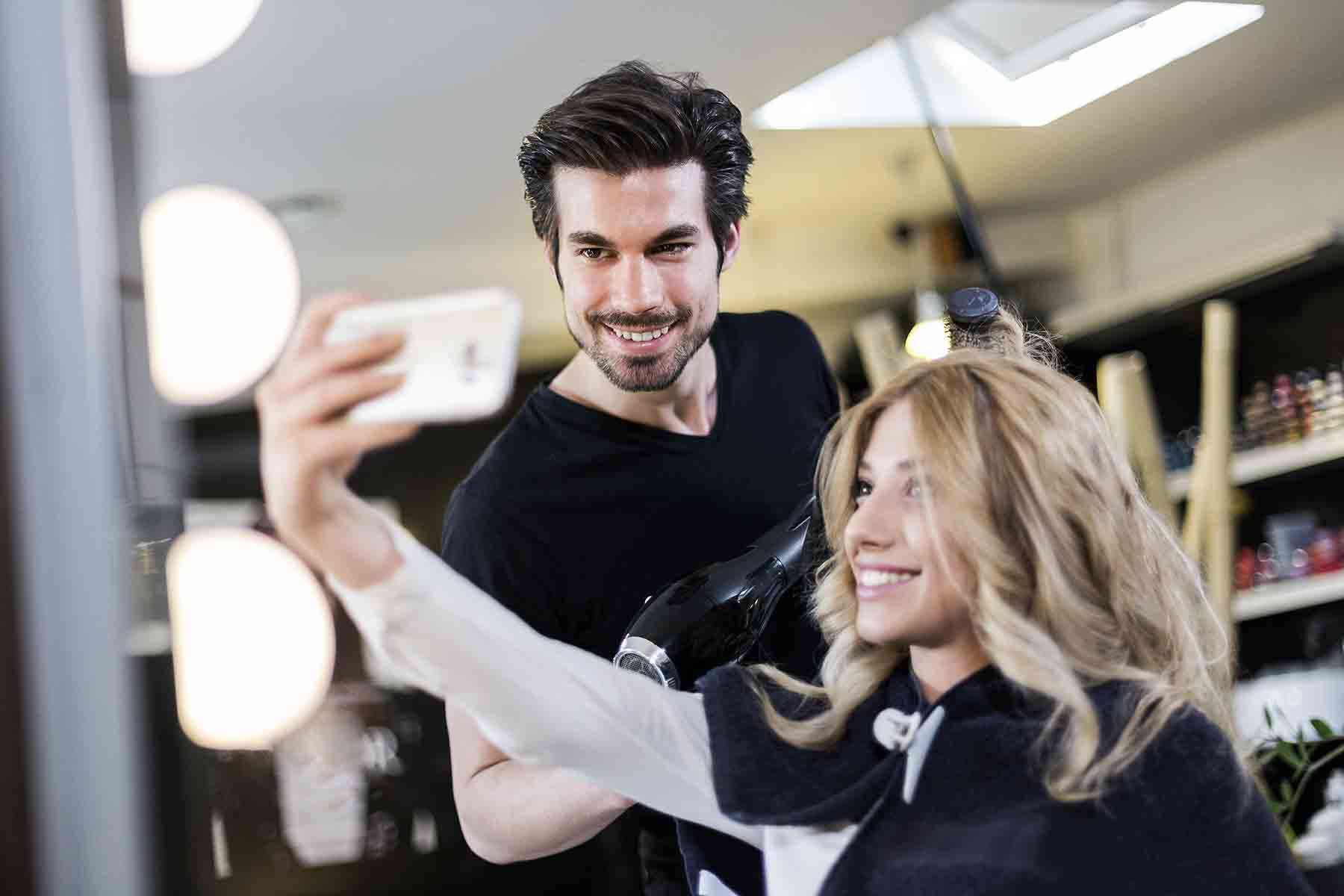 Girl taking a selfie with a hairdresser