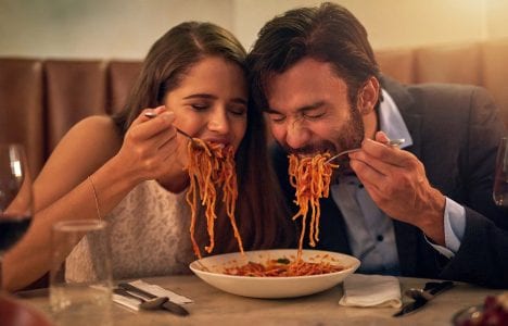 Couple eating spaghetti