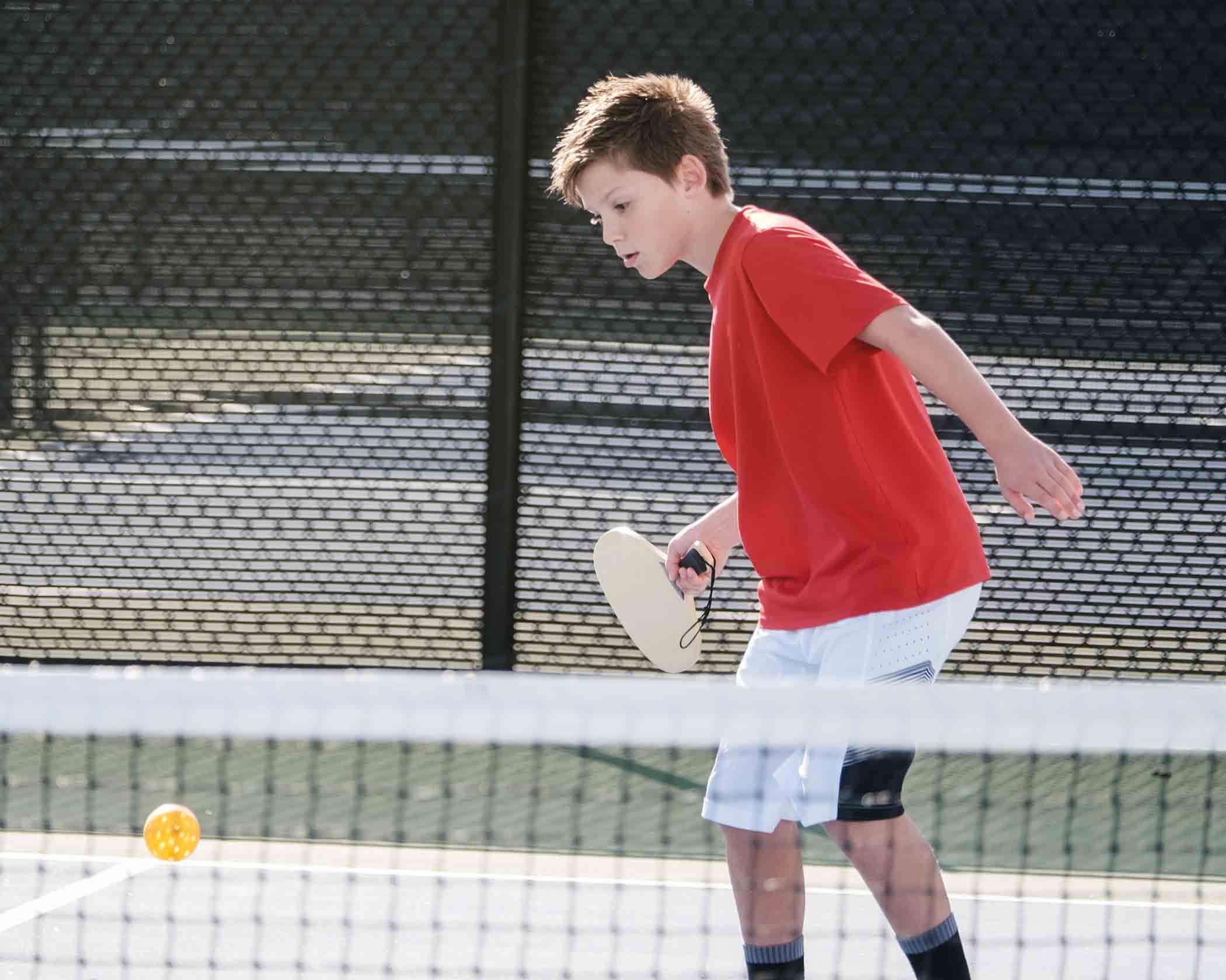 Young boy playing pickleball
