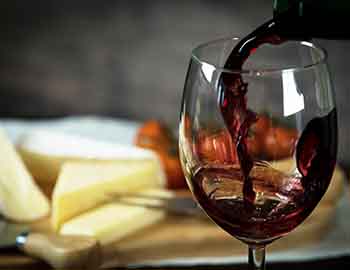 Glass of wine with cheese and grapes