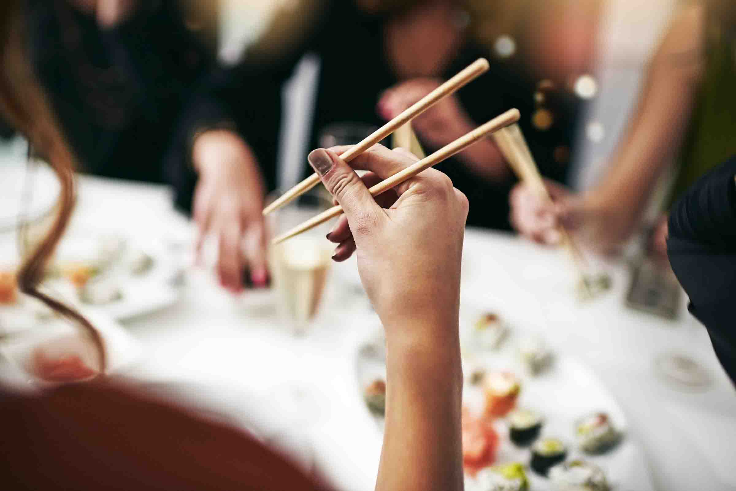 Woman eating with chopsticks